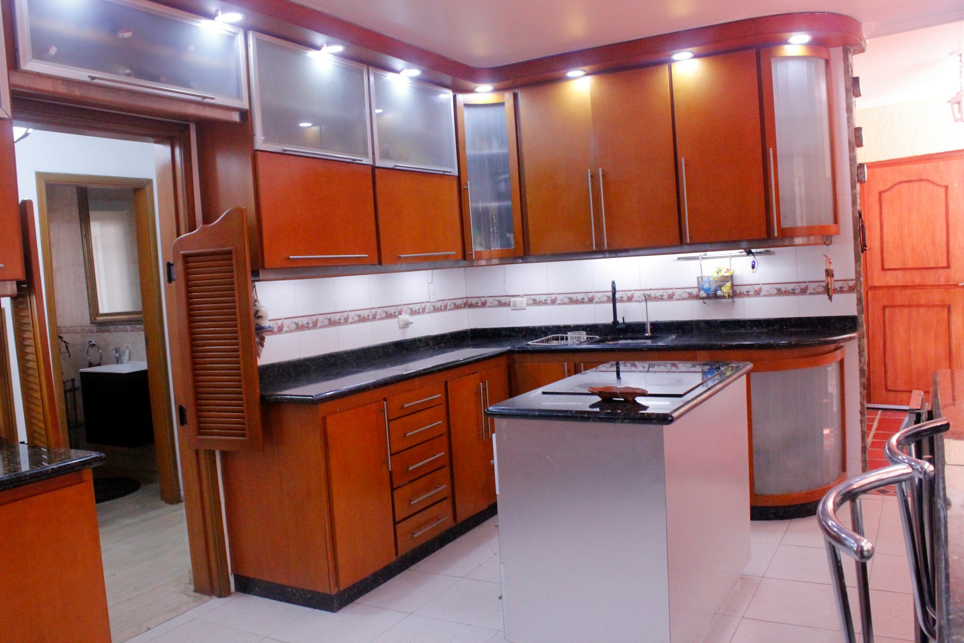 a kitchen with wooden cabinets and black counter tops